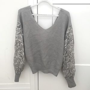 Knit sweater with lace sleeves